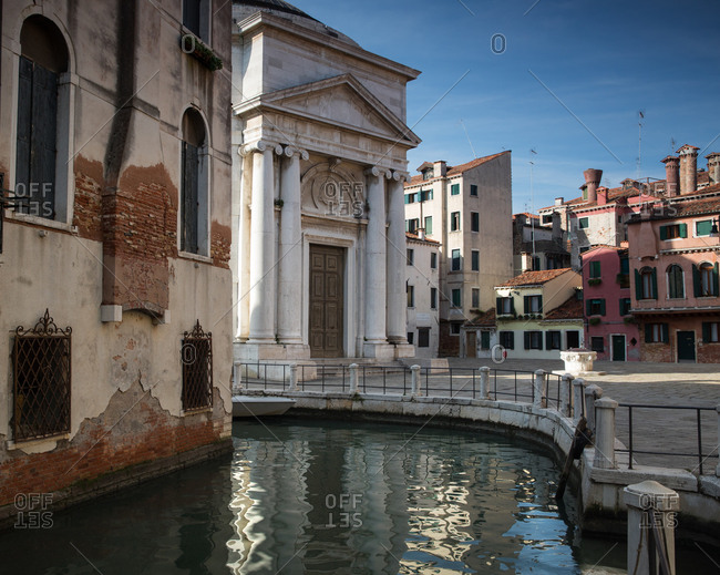 A colorful Venetian canal scene in the daylight hours