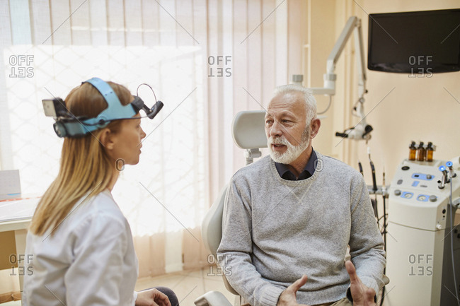 ENT physician talking to senior man in medical practice