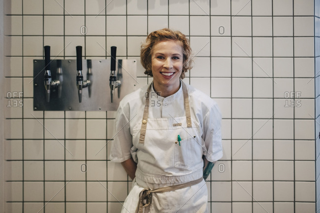Portrait Of Smiling Female Chef, Restaurant Kitchen Wall Tiles