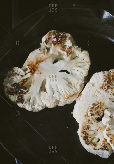 Charred cauliflower steaks on cast-iron skillet