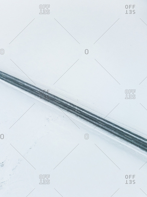 Aerial view of an empty road in the middle of the nordic landscape in winter, Estonia