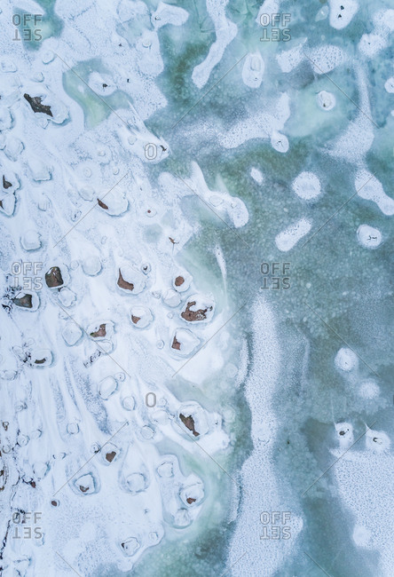 Abstract aerial view of the frozen rocky sea in Muraste, Estonia