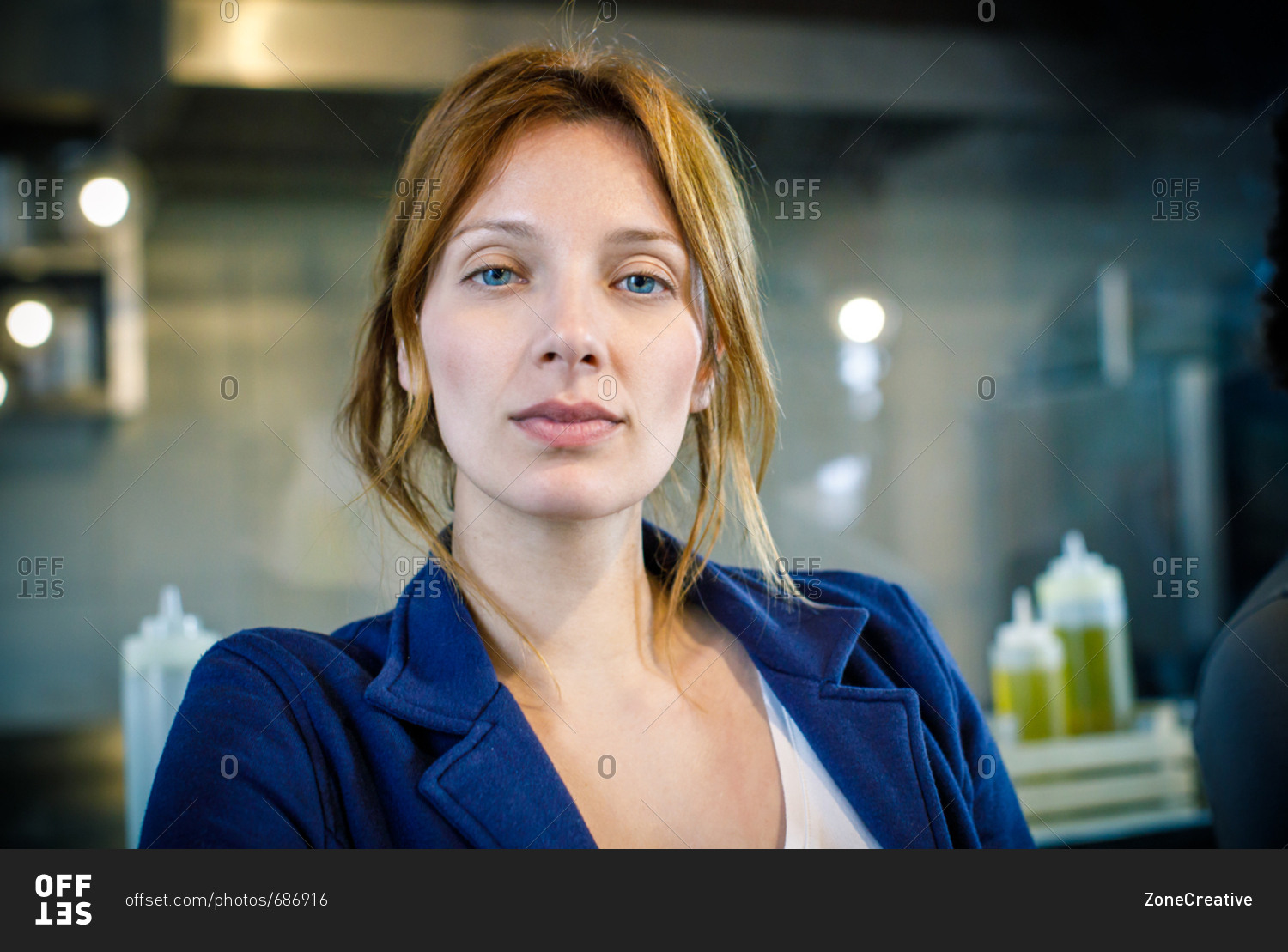 Serious red hair caucasian woman portrait at restaurant lounge bar during work break time