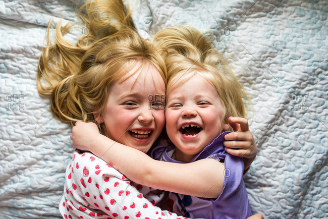 Smiling little girls with their arms around each other