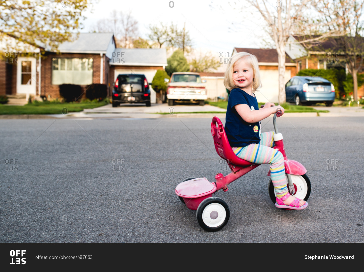 little girl on tricycle