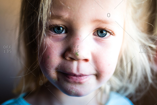 Close up portrait of little girl with messy face