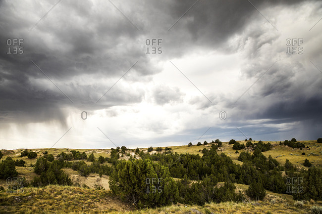 Storm clouds gathering over dry landscape