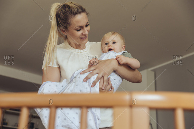 Mother Putting Baby In Its Crib To Sleep Stock Images Page