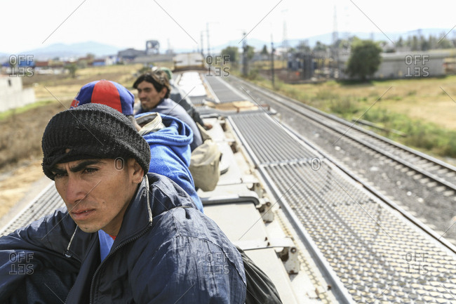 Mexico - November 07, 2007: Young migrants riding on roof of train hoping to cross border into United States of America