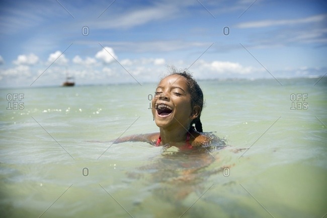 April 6, 2018: Young Girl Swimming In Ocean, Brazil