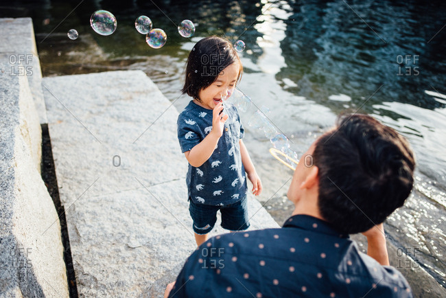 Happy toddler popping bubbles - from the Offset Collection