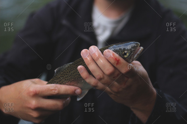 Fisherman holding freshly caught trout
