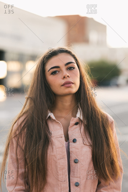 Portrait of long haired young Latina in urban environment