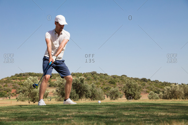 Caucasian Man Swinging Club On Golf Course Stock Photo Offset