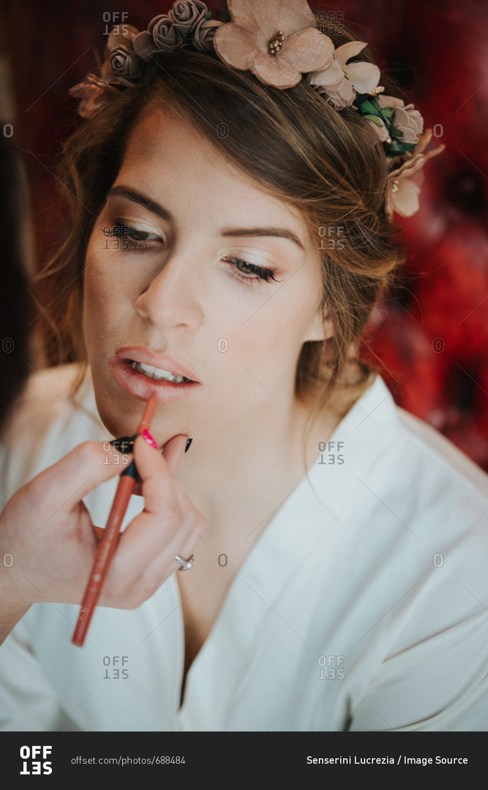 Bride having lip liner applied by make-up artist