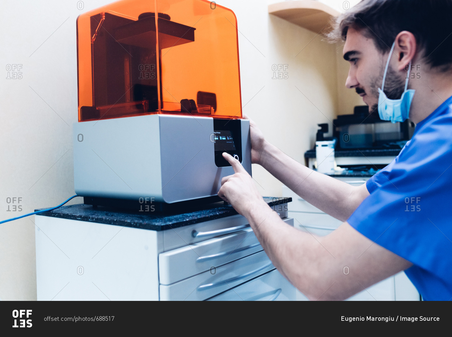 Male dentist using 3D printer