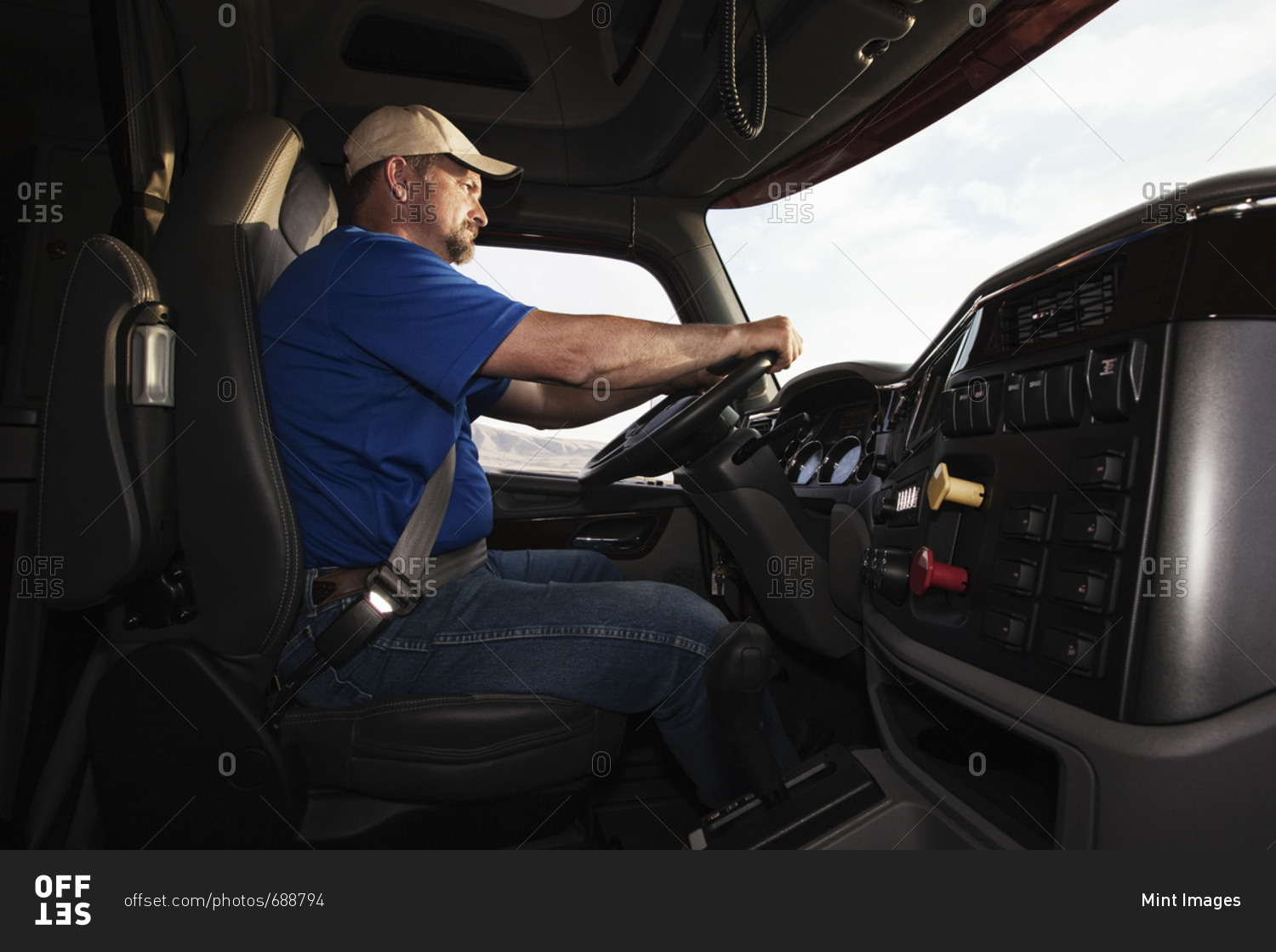 Caucasian man driver in the cab of a  commercial truck