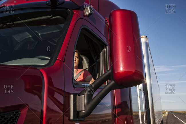 View of a Caucasian woman driver in the cab of her  commercial truck