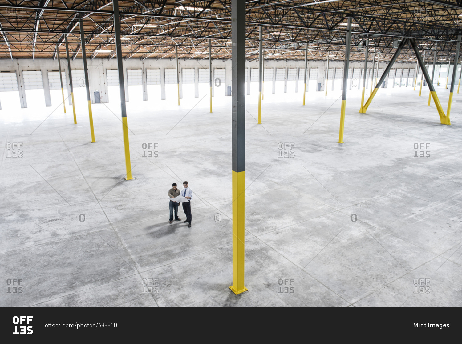 Team of people checking out the new interior of an empty warehouse space
