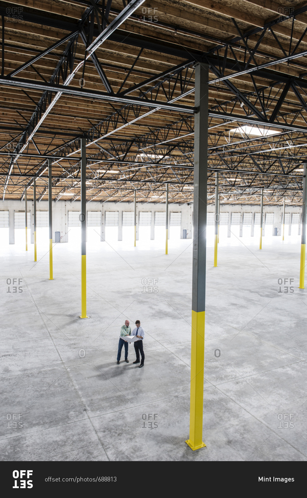 Team of people checking out the new interior of an empty warehouse space