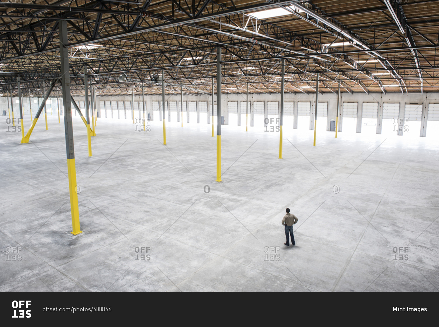 Owner checking out the new interior of a large empty warehouse space
