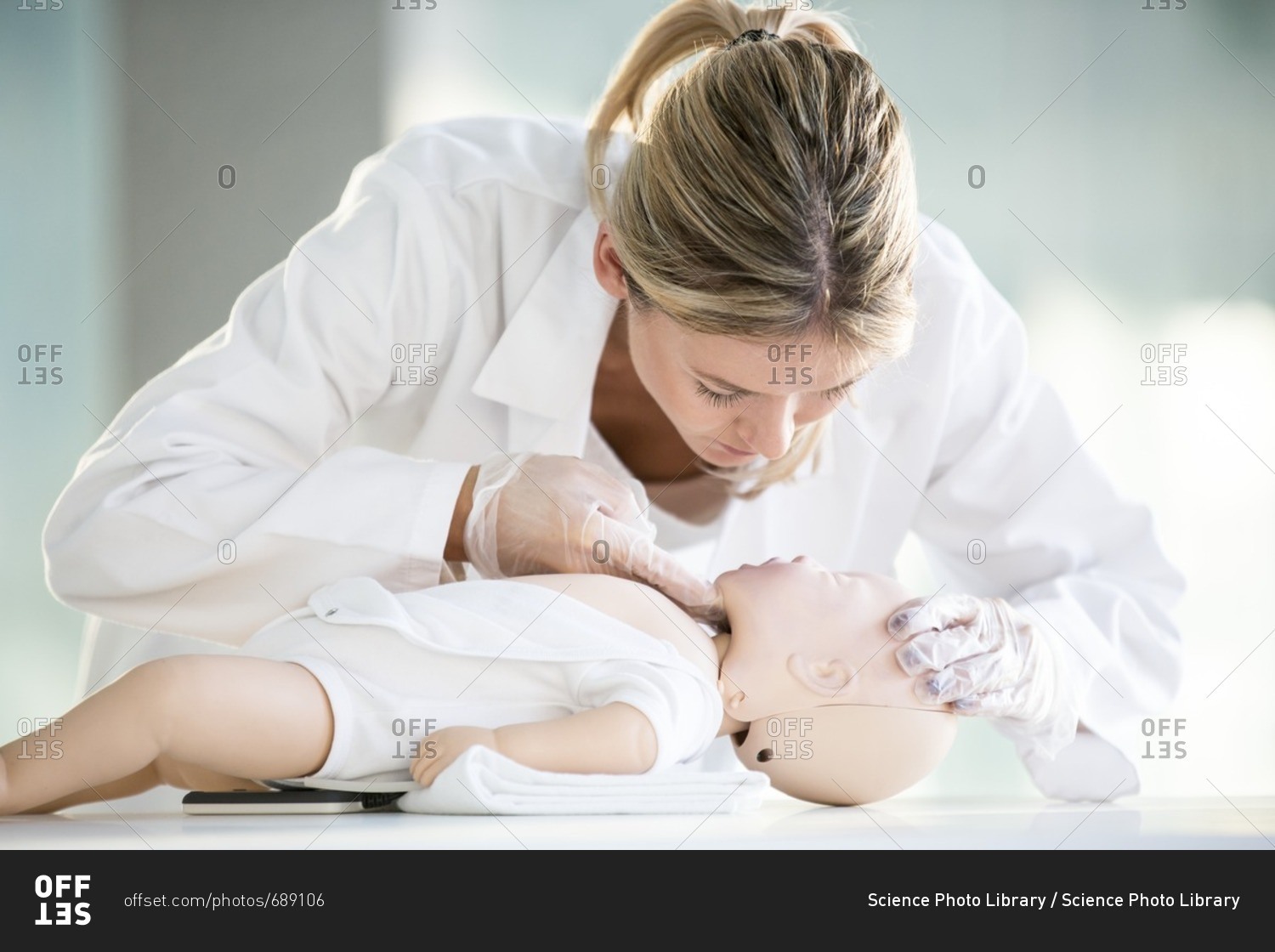 Doctor practicing infant CPR