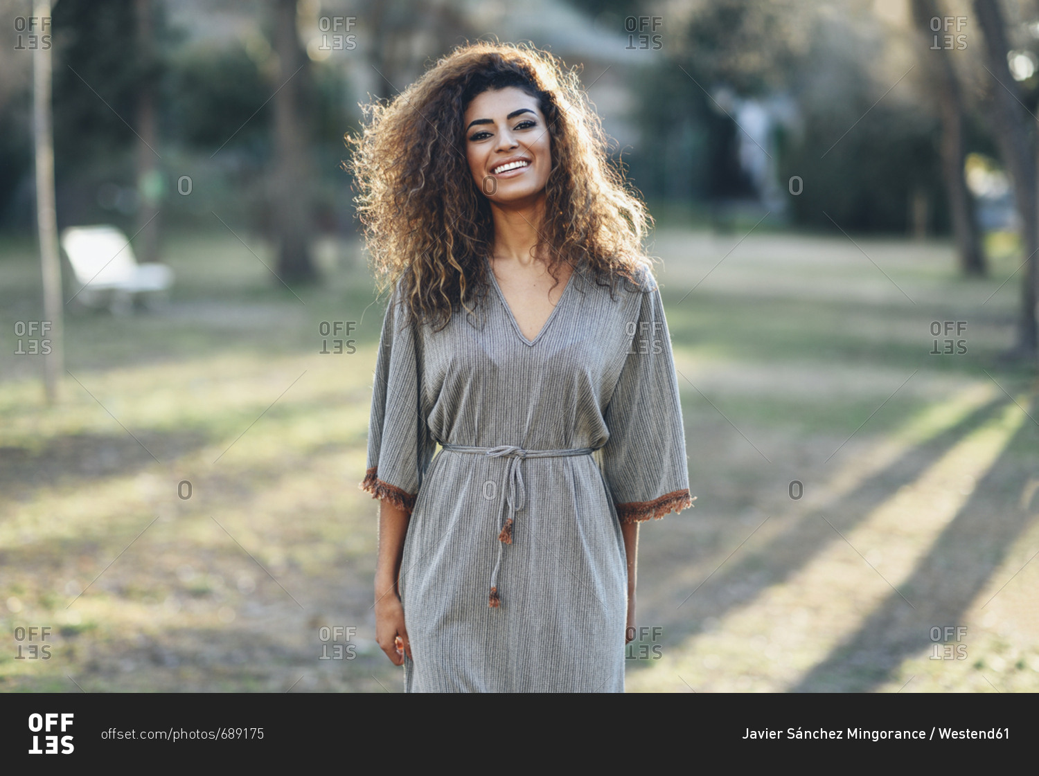 Portrait of happy young woman in a park