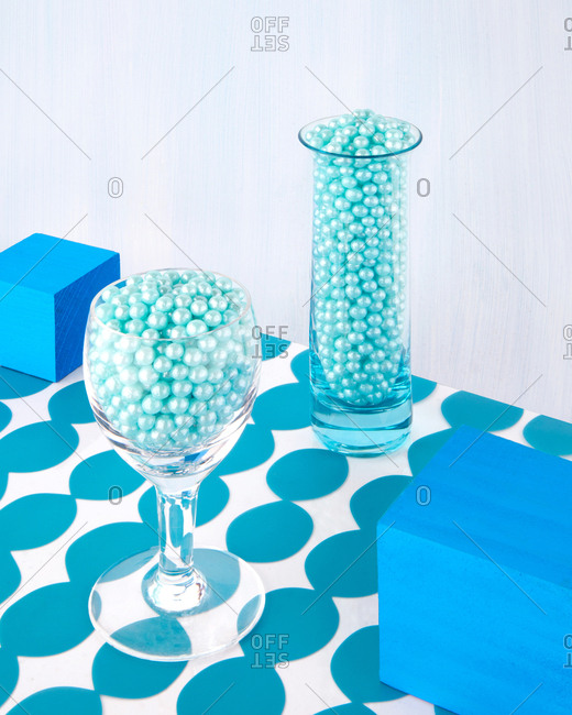 Still life of shiny balls of candy served in glassware