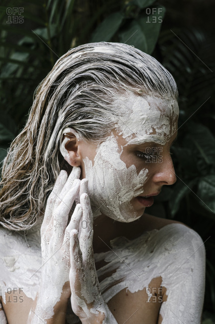 Close up of a woman with white paint all over her body stock photo - OFFSET