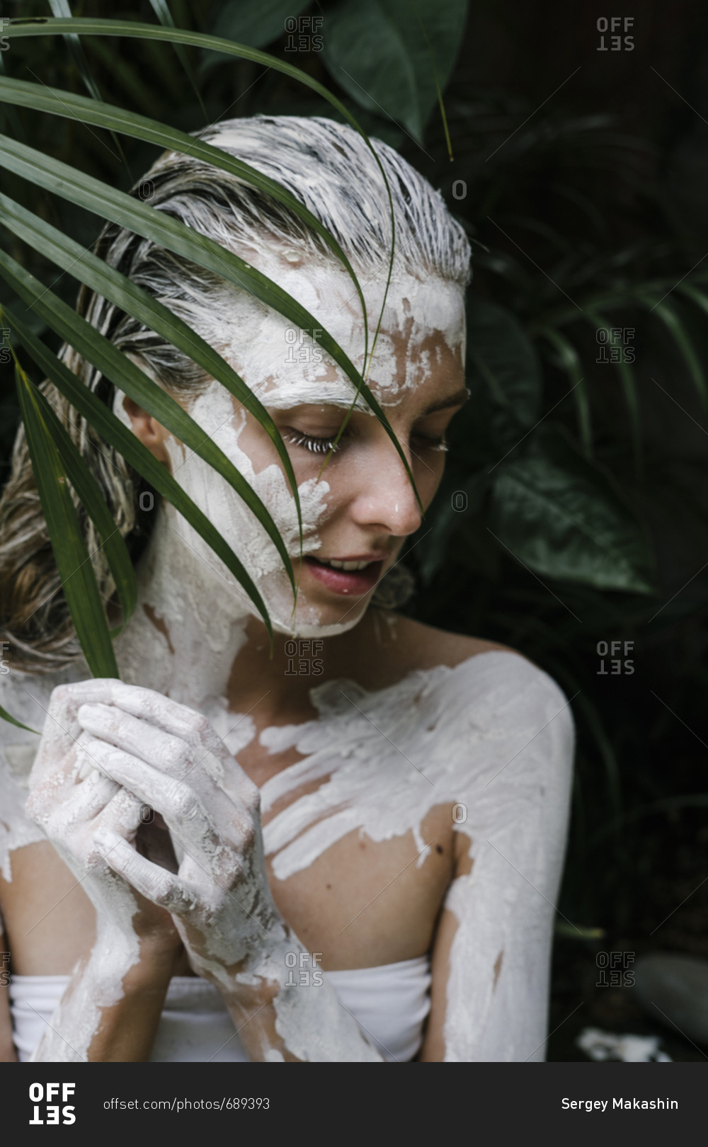 Woman with white paint smeared on her body stock photo - OFFSET
