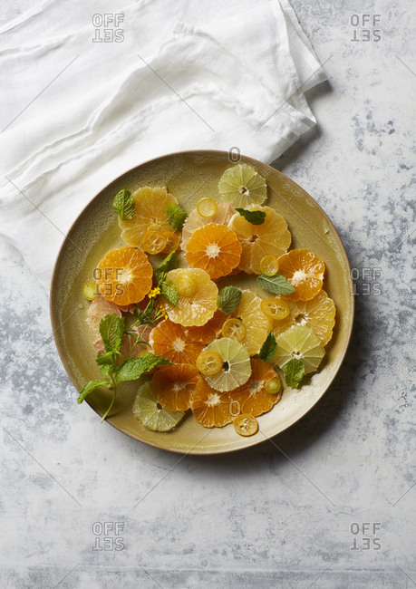 Citrus slices arranged decoratively on round plate