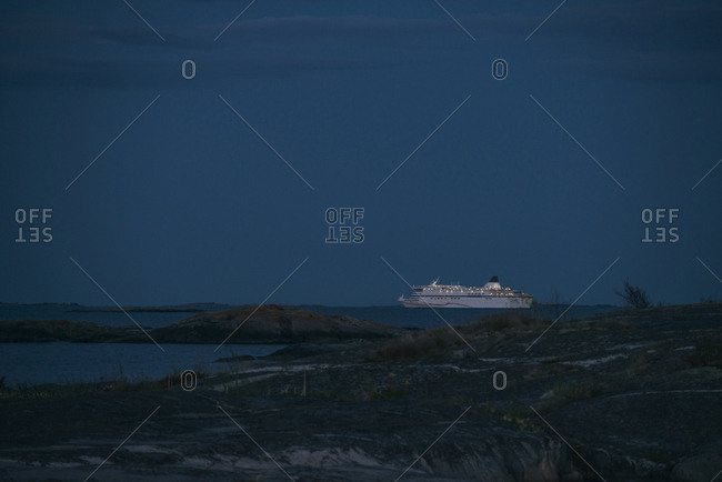 Passenger ship on ocean at dusk