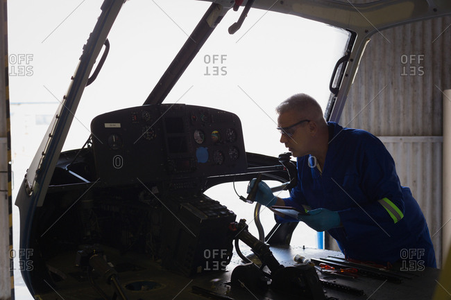 Engineer examining cockpit in aerospace hanger