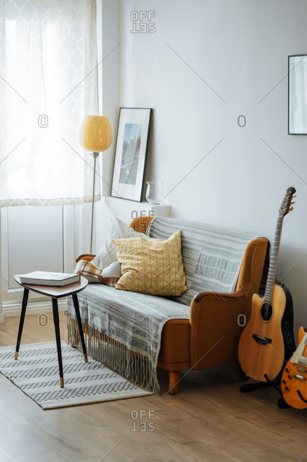 Stylish furniture arrangement in sunlit living room