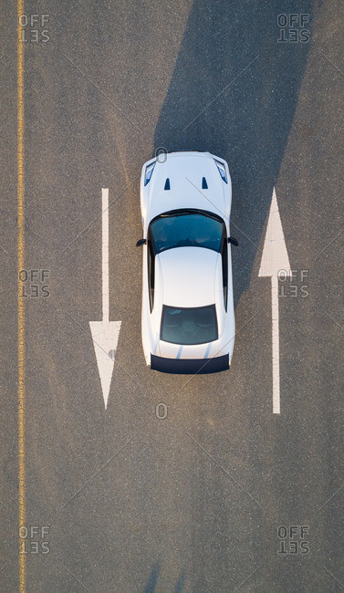 Aerial view of a car on road with arrow signs in Dubai, U.A.E.