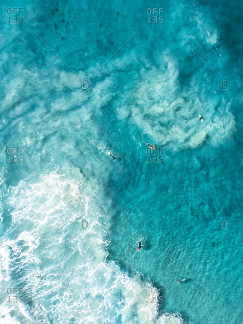 Aerial view of surfers paddling in turquoise waters of Esperance, Australia
