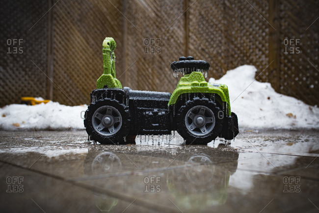 Child's ride-on toy covered in ice