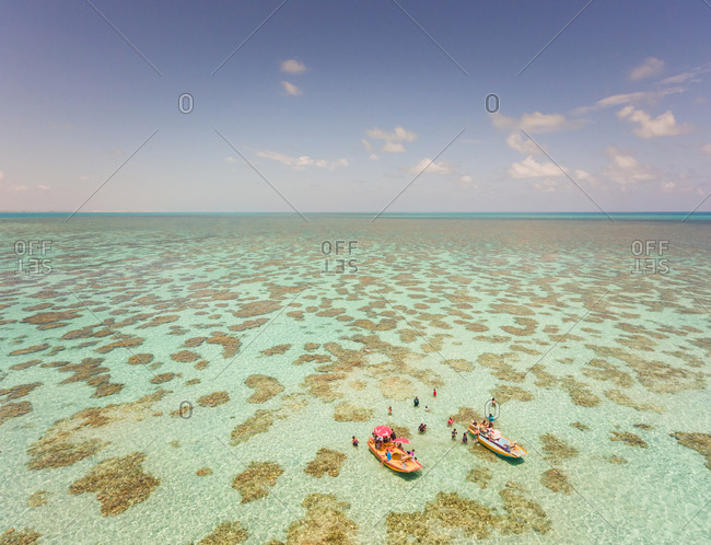 Aerial view of people swimming  and eating on Jangadas, traditional small fishing boats in Rio do Fogo, Brazil.