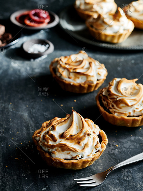 High angle view of Dark Chocolate Tarts topped with meringue
