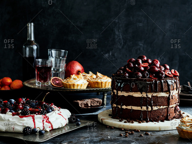 Decadent and delicious assortment of baked desserts arranged against dark slate background
