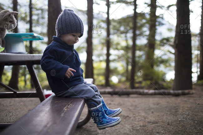 Boy sitting at picnic table, Harrison Hot Springs, British Columbia, Canada
