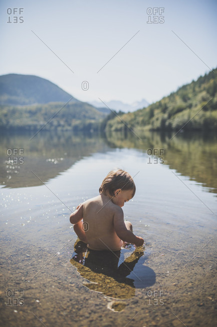 Baby boy playing in Hicks Lake, Harrison Hot Springs, British Columbia, Canada