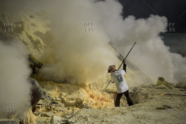 June 13, 2015: Miner extracting sulfur rocks from Kawah Ijen Volcano, East Java, Indonesia