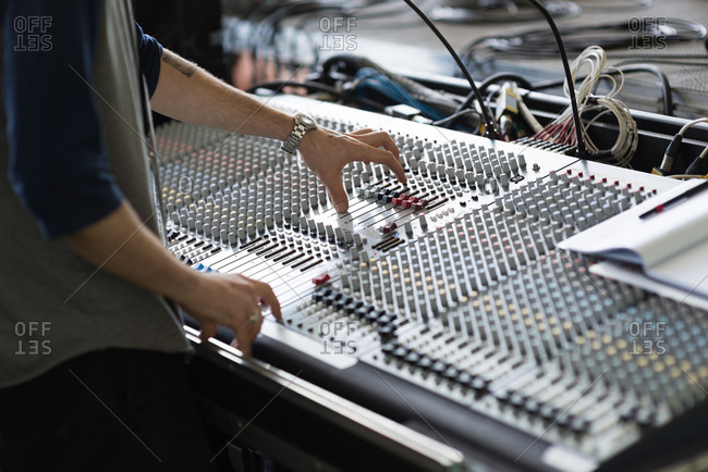 Details of sound equipment being operated by stagehand
