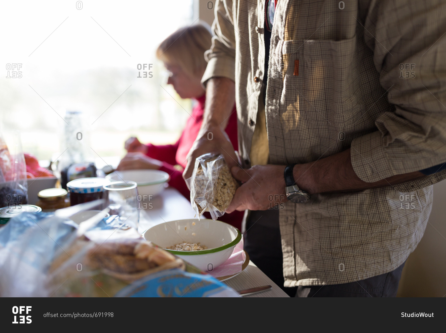 Senior man pouring breakfast cereals