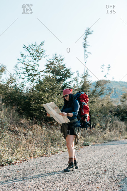 Two backpackers checking a map on a street stock photo