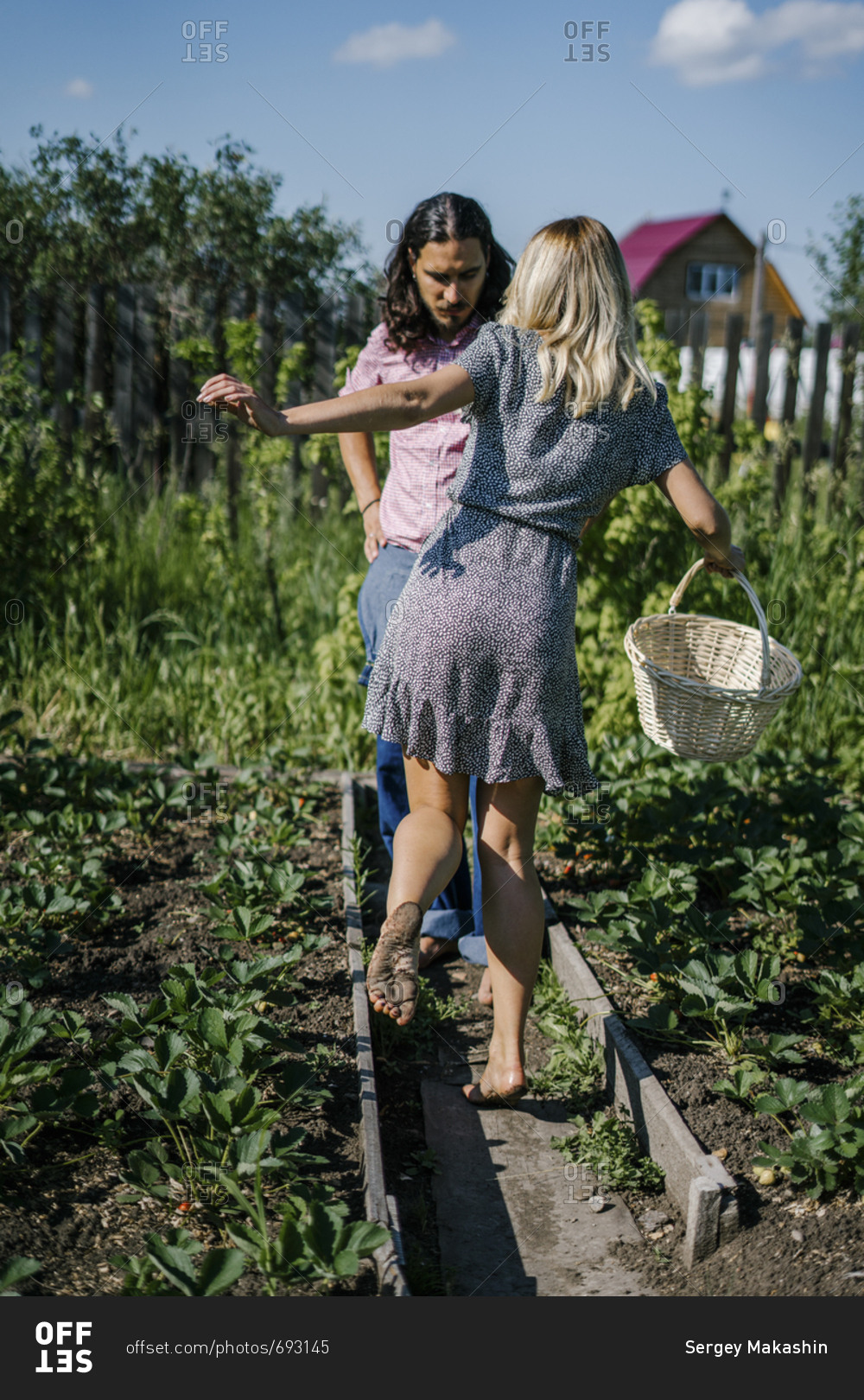 Couple Walking Barefoot In A Garden Stock Photo - OFFSET