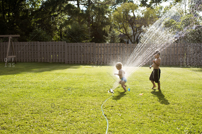 playing in sprinkler