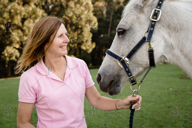 Woman smiling with horse - Offset