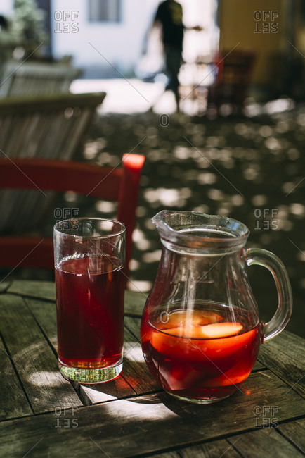 Ice tea in jug and glass outdoors